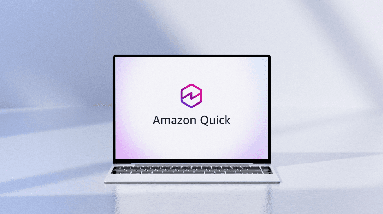 Amazon Quick desktop AI app logo displayed on a silver laptop — product launch hero image